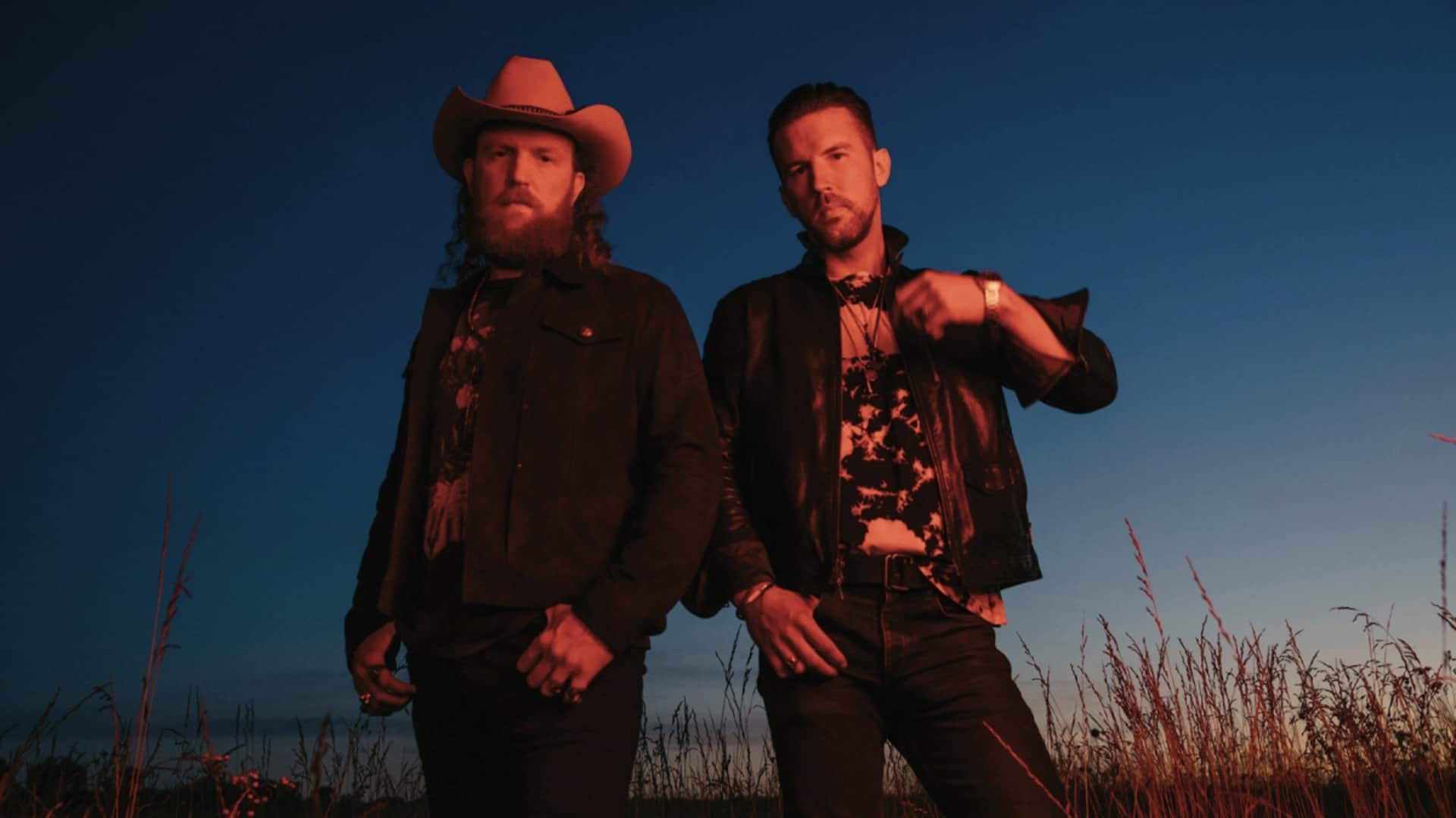 The Brothers Osborne stand in a field