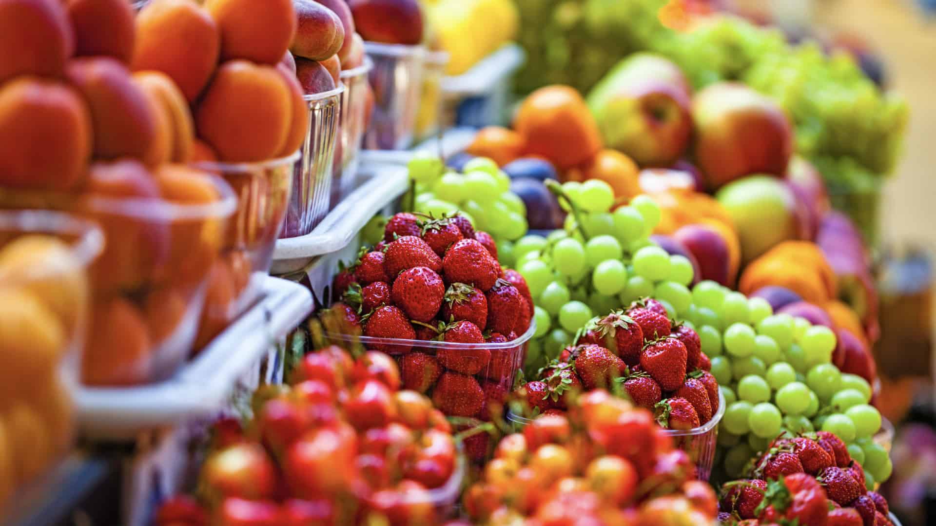 fresh market produce sits on a table at an outdoor farmers market