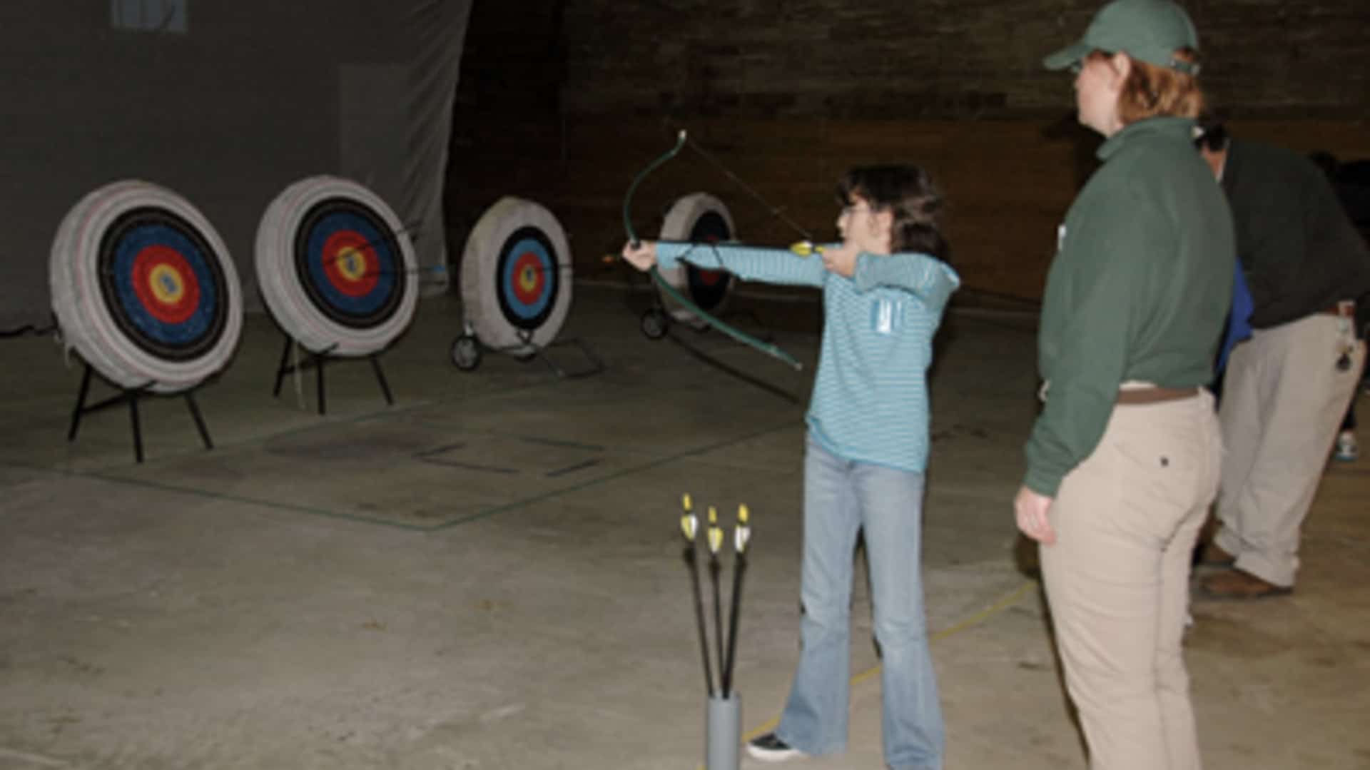 a kid shoots arrows at Open Shoot Archery