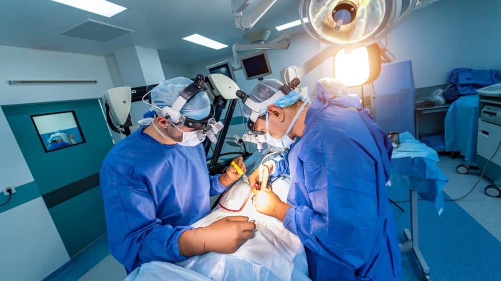 doctors perform spinal neurosurgery