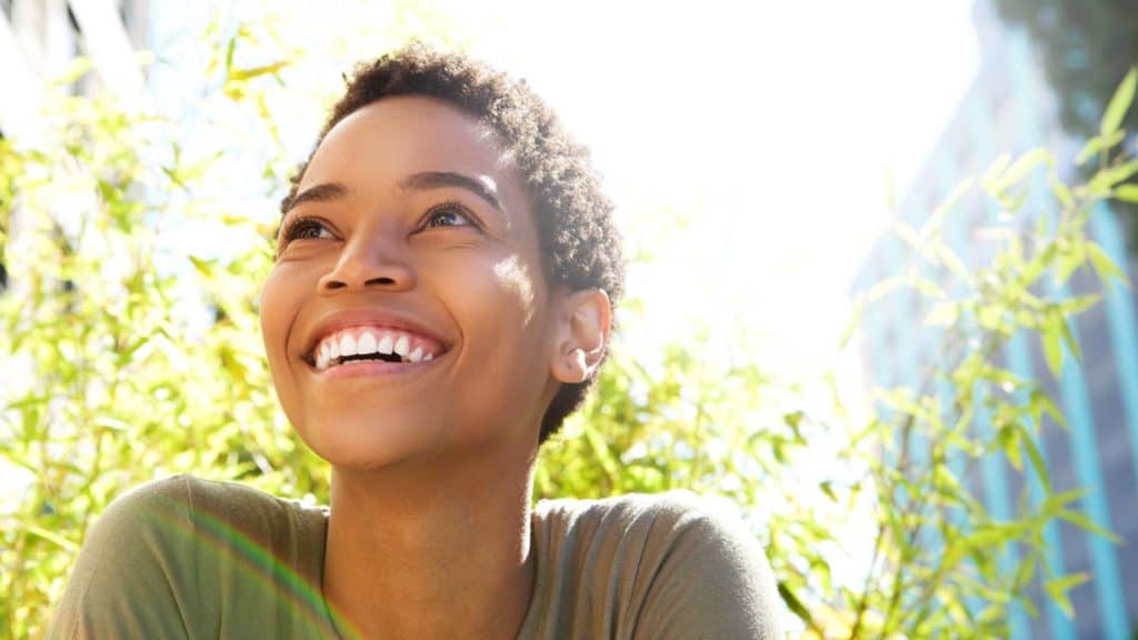 a happy person smiles outdoors