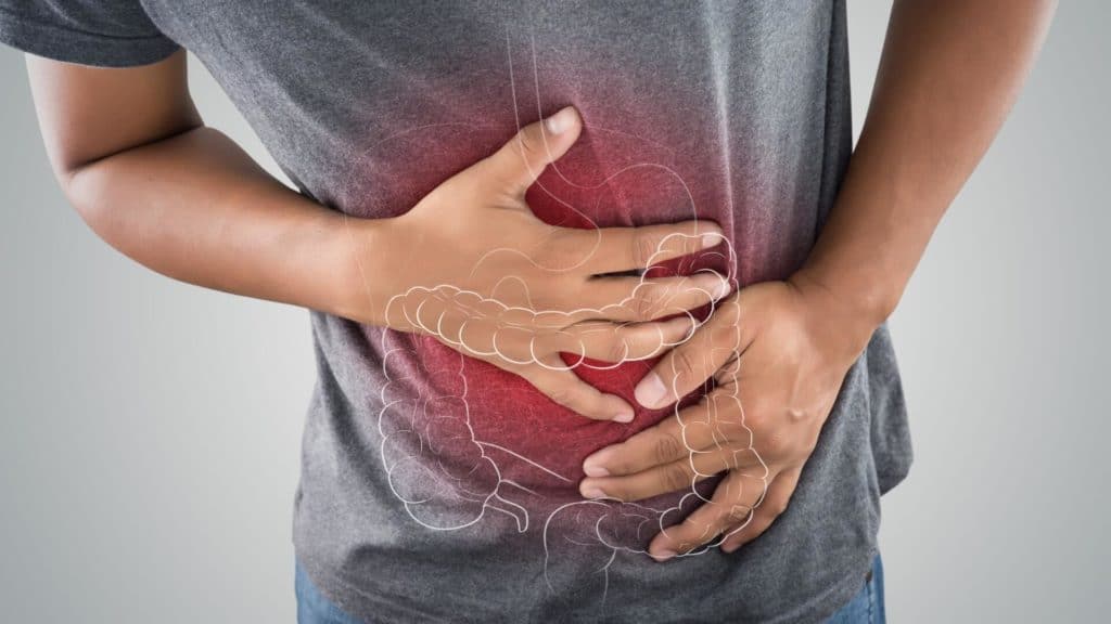 a photo of a large intestine is on a man’s body against a gray background