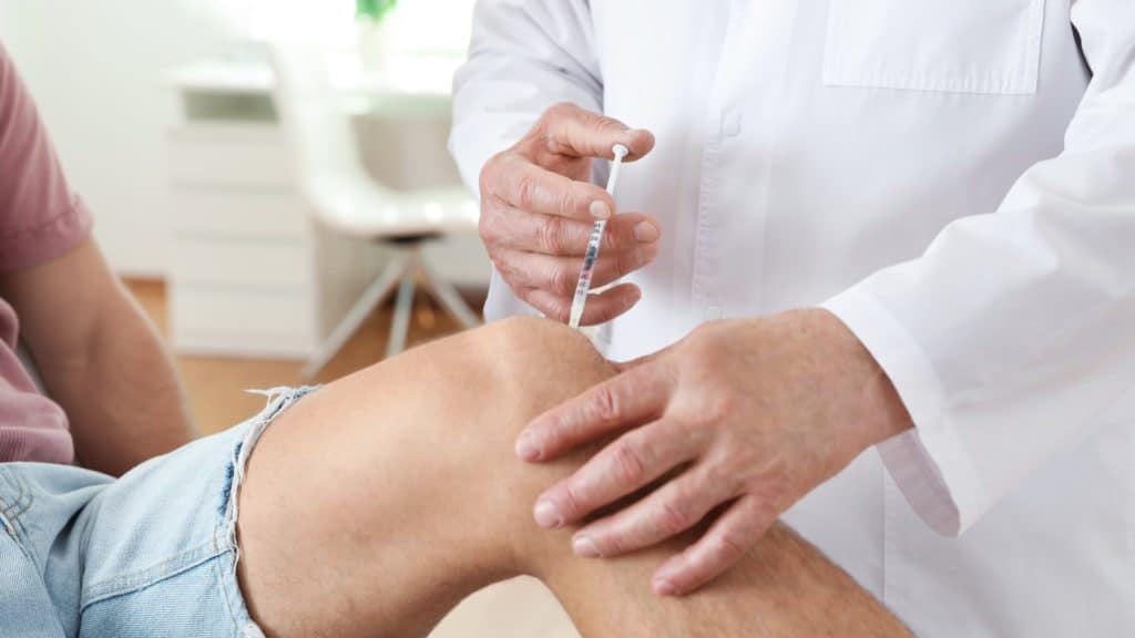 a person receives a knee injection