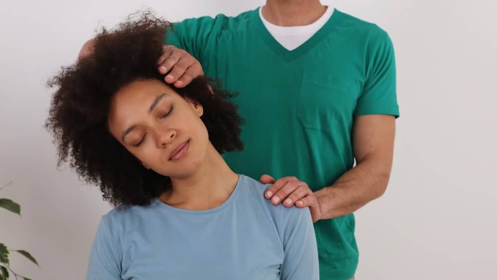 Physical therapist stretched woman's neck | Get Physical Therapy | Northeast Spine and Sports Medicine