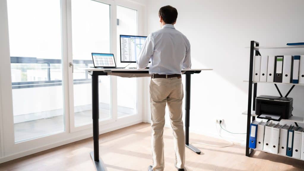 Man using standing desk | Can Tech Neck Be Reversed? | Northeast Spine and Sports Medicine