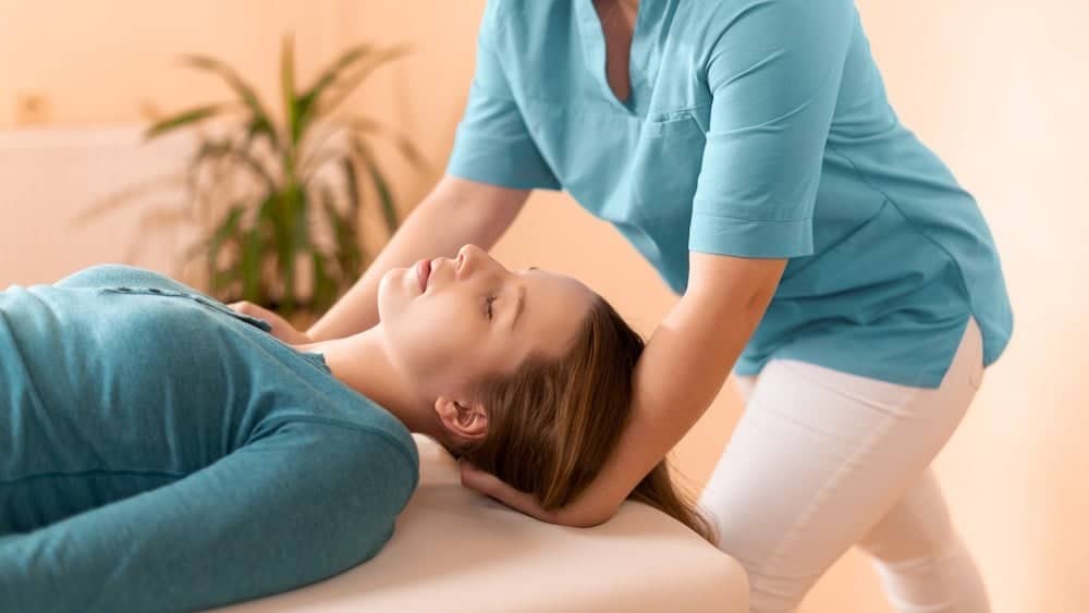 Woman undergoing chiropractic care | See a Chiropractor | Northeast Spine and Sports Medicine
