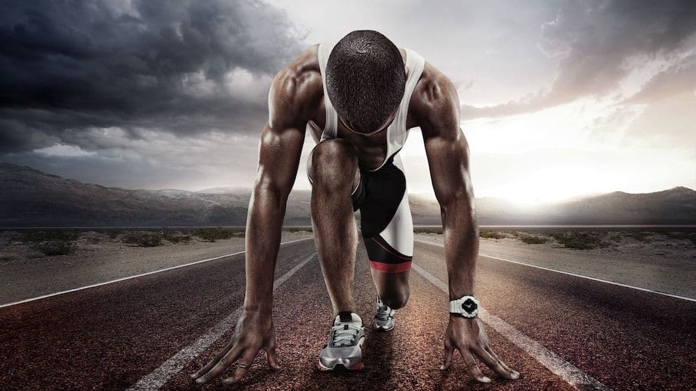 Runner in starting position on a track | Northeast Spine and Sports Medicine