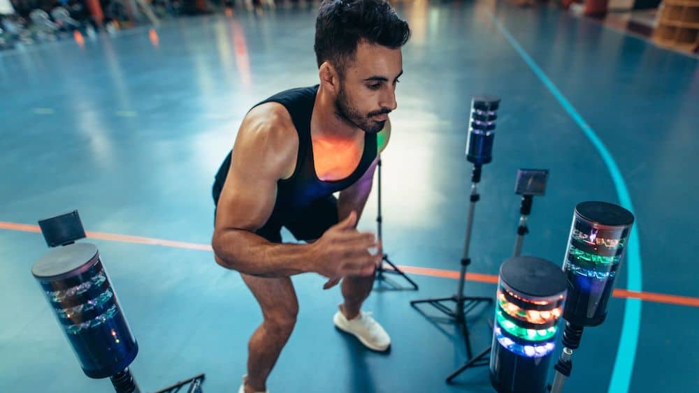 Man testing his reaction time with standing sensors | Northeast Spine and Sports Medicine