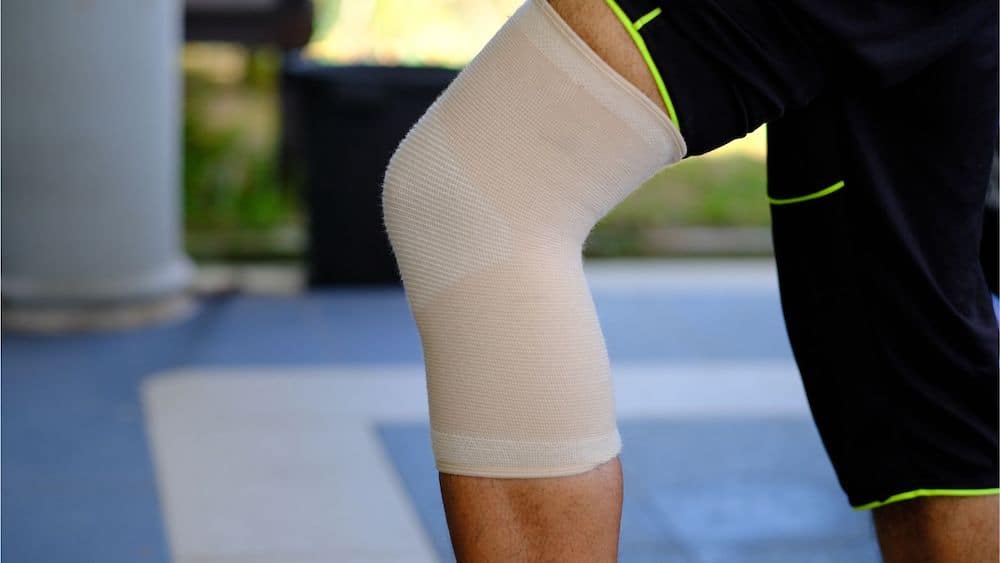 Athlete's knee with beige bandage wrap | Northeast Spine and Sports Medicine