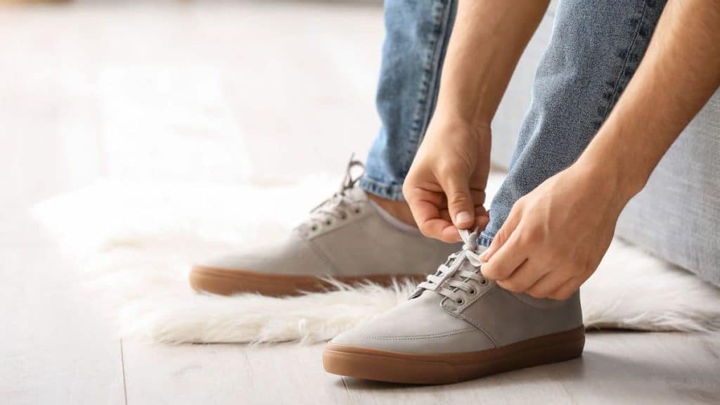 Close up of person tying shoes | Back Pain Treatment at Northeast Spine and Sports Medicine