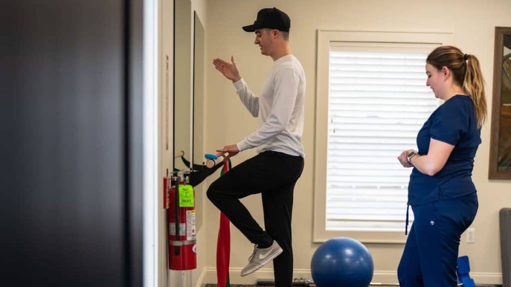 Physical therapist at NorthEast Spine and Sports Medicine helps young patient with balance training | NorthEast Spine and Sports Medicine