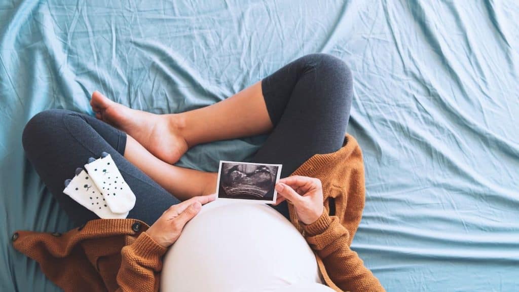 Expectant mother looking at an ultrasound photo | Acupuncture at NorthEast Spine & Sports Medicine