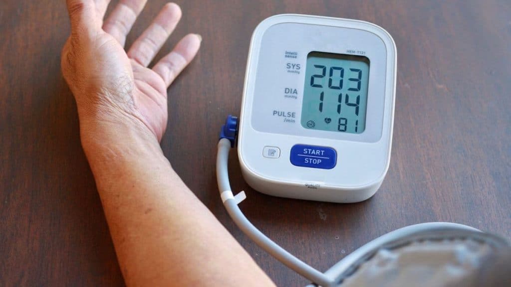 Close up of stressed patient hooked up to a blood pressure monitor | Northeast Spine and Sports Medicine