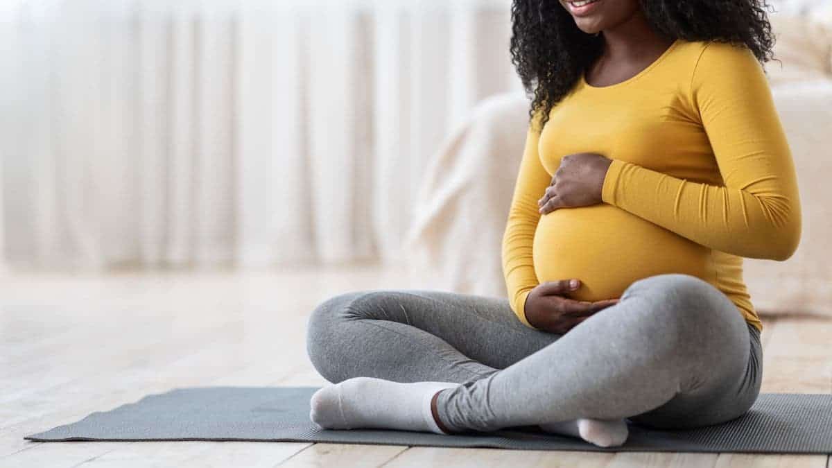Pregnant woman on a yoga mat | Physical therapy at NorthEast Spine and Sports Medicine
